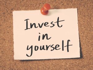 Note that reads "Invest in yourself"