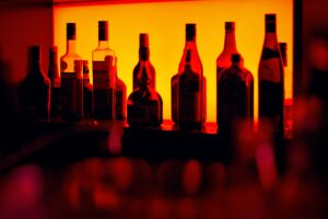 bottles on a shelf in dark lighting